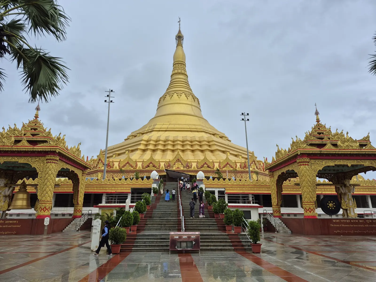 The golden Global Vipassana Pagoda in Mumbai seen from its forecourt, with a central staircase and ornate Burmese-style pavilions on either side